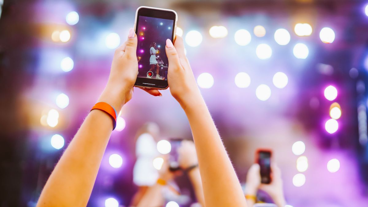 Hand,Held,Smart,Phone,Filming,A,Concert.,Music,Festival.,Youth,