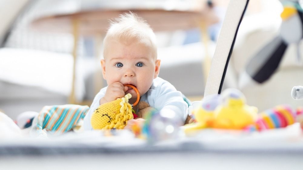 Cute,Baby,Boy,Playing,With,Hanging,Toys,Arch,On,Mat